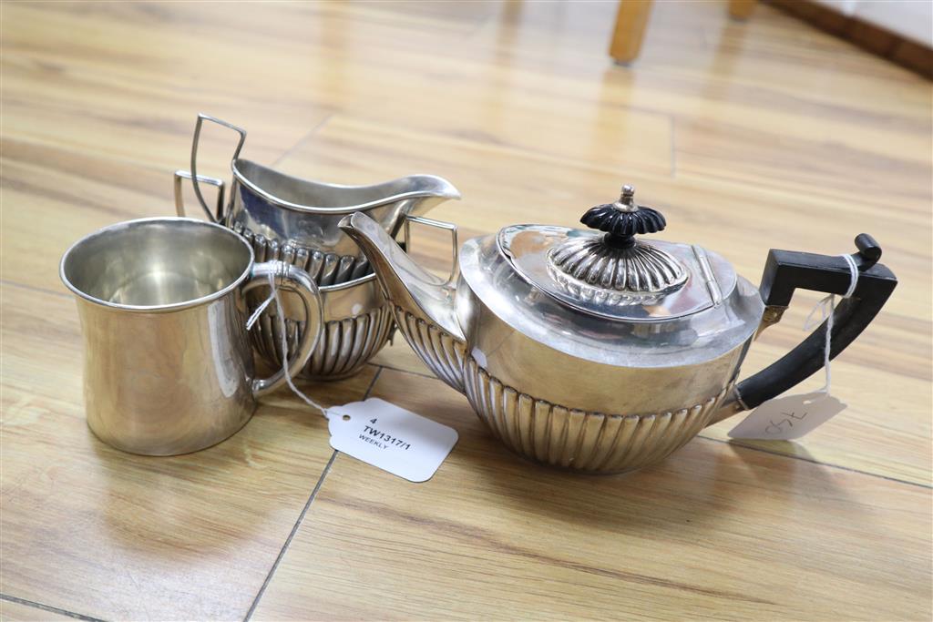 A Sterling three-piece tea service and a silver mug, gross 15oz.